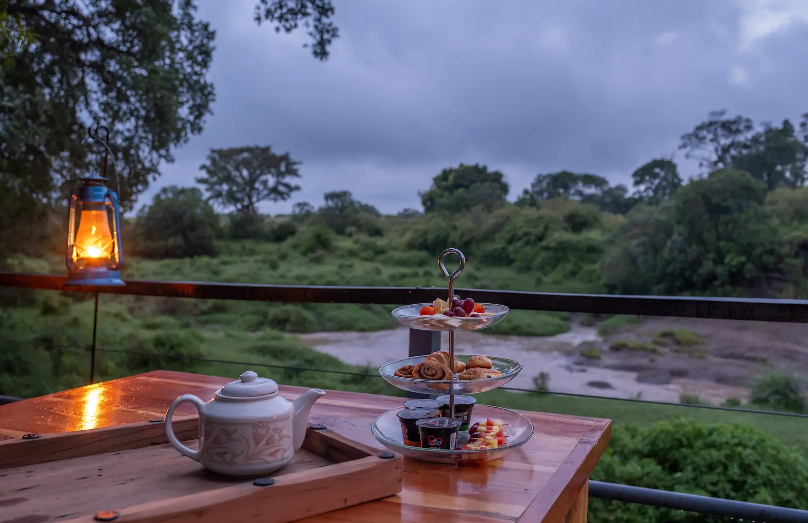 Two lanterns framing the dawn tea service at dusk over the Olare Orok
